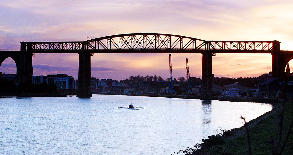 The Boyne Viaduct at Drogheda at dusk, a double scull on the river below